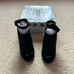 Black suede ankle strap heels.